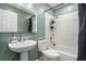 Bathroom with a sleek sink, toilet, and shower-tub combination, illuminated by a modern mirror light at 6717 Atwood Ave, Las Vegas, NV 89108