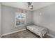 Bedroom featuring a twin bed, ceiling fan, and a bright window showcasing the outdoor scenery at 6717 Atwood Ave, Las Vegas, NV 89108