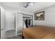 Bedroom featuring an open closet and door to the hallway, complete with stylish painting and ceiling fan at 6717 Atwood Ave, Las Vegas, NV 89108