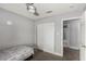 Bedroom featuring closet with sliding doors and a bed with scenic view outside window and ceiling fan at 6717 Atwood Ave, Las Vegas, NV 89108