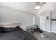 Bedroom featuring a bed with a sleek black comforter, complemented by a glass desk, perfect for study or work at 6717 Atwood Ave, Las Vegas, NV 89108