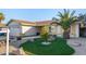 Single-story home with desert landscaping and green lawn with palm tree at 6717 Atwood Ave, Las Vegas, NV 89108