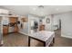 Open-concept kitchen with stainless steel appliances and wood cabinets, seamlessly flowing into the dining area at 6717 Atwood Ave, Las Vegas, NV 89108