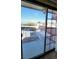 Balcony view showcases the community parking and a distant mountain range, framed by a sliding glass door at 701 Bourbon St # G3, Pahrump, NV 89048