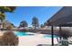 Outdoor pool with a lounge area for residents to enjoy on a bright day at 701 Bourbon St # G3, Pahrump, NV 89048