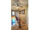 Upstairs hallway with wood floors, decorative pictures, and a ceiling fan at 701 Bourbon St # G3, Pahrump, NV 89048