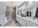 A primary bathroom with a double sink vanity and walk-in glass shower at 7153 Tavita St, Las Vegas, NV 89113