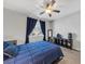 Bedroom with window, mirror, and a ceiling fan above a bed at 7153 Tavita St, Las Vegas, NV 89113