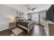 Main bedroom features hardwood floors, neutral colors, large window and a large television at 7153 Tavita St, Las Vegas, NV 89113