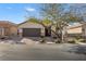 Inviting single-story home featuring a well-manicured yard and a two-car garage at 7153 Tavita St, Las Vegas, NV 89113