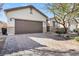 Spacious two-car garage with a paved driveway and stone veneer accents at 7153 Tavita St, Las Vegas, NV 89113