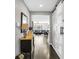 Hallway featuring a wood floor, sliding barn door, and view into the living room at 7153 Tavita St, Las Vegas, NV 89113