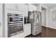 Modern kitchen featuring stainless steel appliances, white cabinets and dark wood floors at 7153 Tavita St, Las Vegas, NV 89113