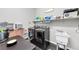 Efficient laundry room equipped with modern appliances, a sink, and storage shelves at 7153 Tavita St, Las Vegas, NV 89113