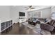 Living room with hardwood floors, media center and comfortable seating, bathed in natural light at 7153 Tavita St, Las Vegas, NV 89113