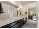 A spacious bathroom with double sinks, dark cabinets, and a doorway leading to the main bedroom at 733 Aberdeen Tartan St, Las Vegas, NV 89138