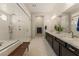 Bright bathroom featuring double sink vanity with marble counters and walk-in shower at 733 Aberdeen Tartan St, Las Vegas, NV 89138