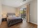 Serene bedroom with hardwood floors, neutral tones, and a sliding glass door leading to a private patio at 733 Aberdeen Tartan St, Las Vegas, NV 89138