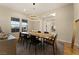 Bright dining room featuring a modern chandelier, large windows, and stylish decor at 733 Aberdeen Tartan St, Las Vegas, NV 89138