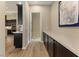 Hallway with hardwood floors, built-in cabinetry, and access to the kitchen showcasing modern appliances at 733 Aberdeen Tartan St, Las Vegas, NV 89138