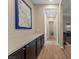 Bright hallway with hardwood floors, dark cabinets with light countertops, and stylish wall art at 733 Aberdeen Tartan St, Las Vegas, NV 89138