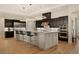 A spacious kitchen featuring black cabinets, pendant lighting, and a large center island at 733 Aberdeen Tartan St, Las Vegas, NV 89138