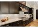 Modern kitchen features dark cabinetry, marble backsplash, and stainless steel KitchenAid appliances at 733 Aberdeen Tartan St, Las Vegas, NV 89138