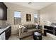 Comfortable living room with a wet bar, sofa, stylish decor, and natural light from two windows at 733 Aberdeen Tartan St, Las Vegas, NV 89138