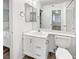 Bathroom featuring a single sink vanity with a framed mirror and wood-look floors at 7400 W Flamingo Rd # 2022, Las Vegas, NV 89147