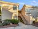 Condominium exterior with maintained landscaping and stairs leading to the units at 7400 W Flamingo Rd # 2022, Las Vegas, NV 89147