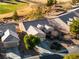 Aerial view of a well-maintained single story home with mature trees and a lush green golf course in the background at 7505 Chaffinch St, North Las Vegas, NV 89084