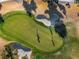 Golfers enjoying the lush, green putting green and sand trap on a sunny day at 7505 Chaffinch St, North Las Vegas, NV 89084