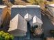 A close aerial view of a beige single-story home with an attached garage and desert landscaping and solar panels at 7505 Chaffinch St, North Las Vegas, NV 89084