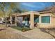 Covered patio and backyard featuring an outdoor seating area and desert landscaping at 7505 Chaffinch St, North Las Vegas, NV 89084