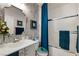 Bathroom featuring gray marble wallpaper, a shower with a glass door, and vanity at 7505 Chaffinch St, North Las Vegas, NV 89084