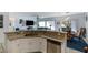 Open floor plan showing the kitchen and breakfast bar, with stainless steel appliances and granite countertops at 7505 Chaffinch St, North Las Vegas, NV 89084