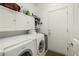 Clean laundry room with a washer, dryer, and storage cabinets at 7505 Chaffinch St, North Las Vegas, NV 89084