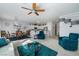 Open floor plan living room showcasing comfortable seating and a dining area adjacent to a granite countertop kitchen at 7505 Chaffinch St, North Las Vegas, NV 89084