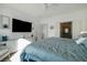 Spacious main bedroom featuring a large television, ensuite access, and neutral color palette at 7505 Chaffinch St, North Las Vegas, NV 89084