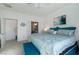 Bright primary suite featuring plush blue bedding, artwork, and ensuite bathroom access at 7505 Chaffinch St, North Las Vegas, NV 89084