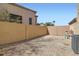 Enclosed backyard features desert landscaping for low maintenance and block wall for added privacy at 767 Durgos Dr, Henderson, NV 89012