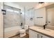 Well-lit bathroom features modern fixtures, marble-look tile surround, and a sleek, minimalist design at 767 Durgos Dr, Henderson, NV 89012