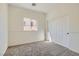 Simple bedroom with neutral carpet, white walls, closet, and a window providing natural light at 767 Durgos Dr, Henderson, NV 89012