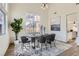 Open dining room with a modern chandelier and large window providing natural light at 767 Durgos Dr, Henderson, NV 89012