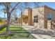 Back of the home features a covered balcony, desert landscaping, and stucco exterior at 767 Durgos Dr, Henderson, NV 89012