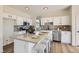 Image features a modern kitchen with a white island and stainless steel appliances at 767 Durgos Dr, Henderson, NV 89012