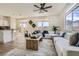 Bright living room featuring a large white sectional, wood coffee table, and modern decor, creating an inviting space at 767 Durgos Dr, Henderson, NV 89012