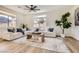 Bright living room with a sectional sofa, a view of the mountains, and wood floors at 767 Durgos Dr, Henderson, NV 89012