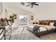 Cozy main bedroom featuring a gray bed, plush carpet, and sliding glass doors to a balcony with mountain views at 767 Durgos Dr, Henderson, NV 89012