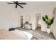 Airy main bedroom with neutral walls, ceiling fan, carpet, and a glimpse into the attached ensuite bathroom at 767 Durgos Dr, Henderson, NV 89012